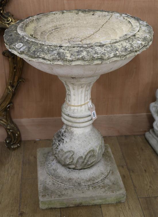 A reconstituted garden bird bath, raised on a square plinth W.61cm
